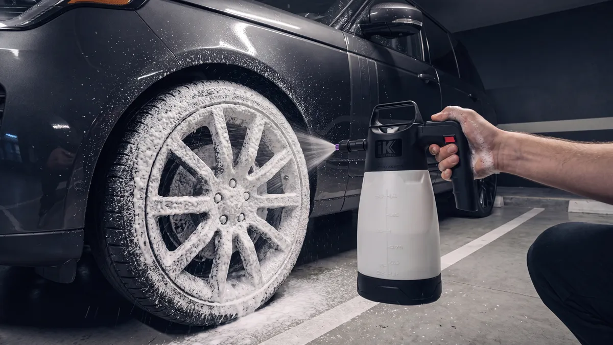 A wheel being foamed and cleaned with dedicated tools